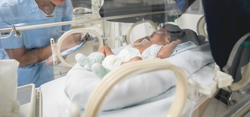 baby in nicu next to doctor